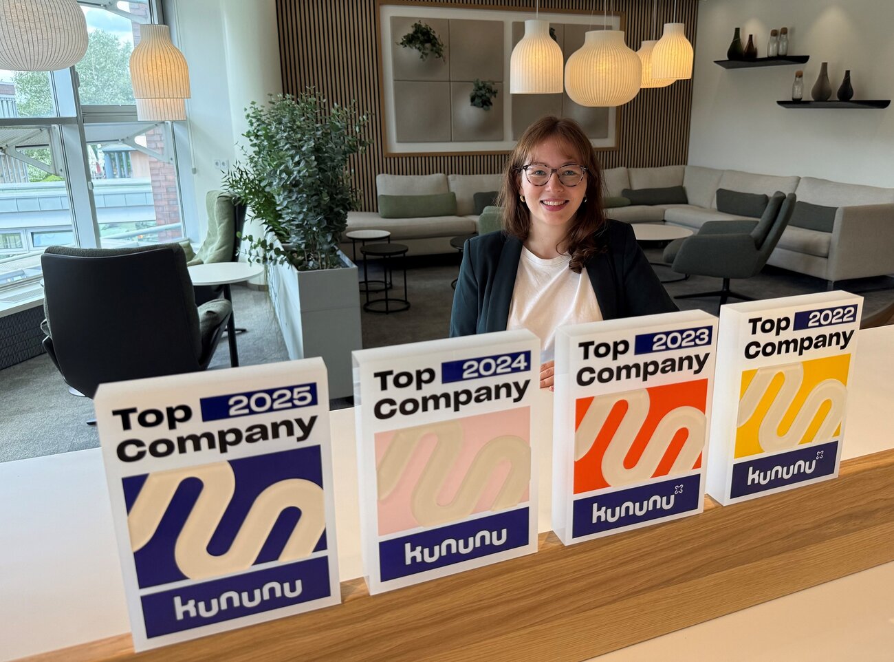Sparkassen-Recruiterin Anna ist zusammen mit vier Auszeichnungen von Kununu "Top Company" zu sehen.
